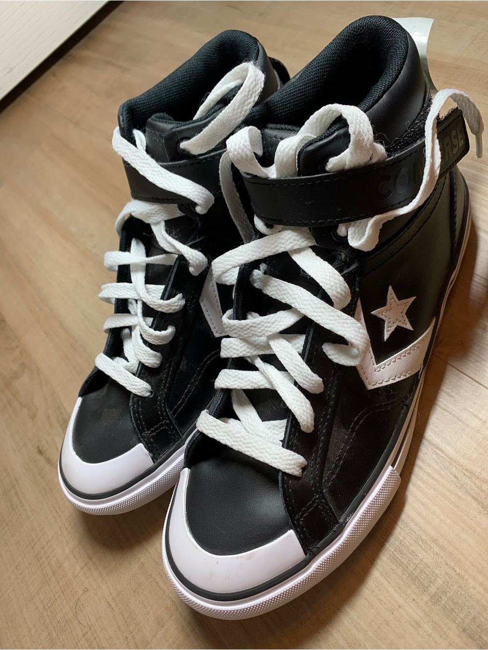 Converse All-Star Blaze Kids Black and White High-Top Sneakers with Star Accent.